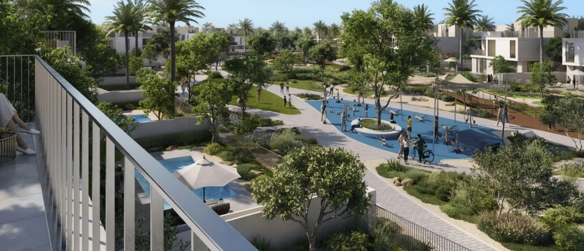 View over a landscaped community park with pools, palm trees and villas in The Valley, Dubai